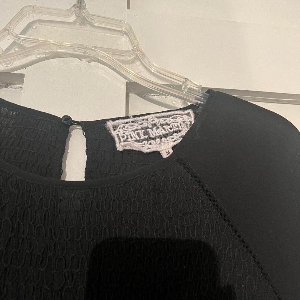 Cute black top with smocking.